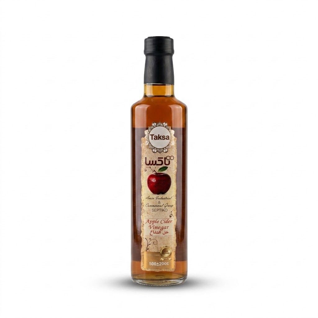 Bottle of Taksa apple cider vinegar on a white background