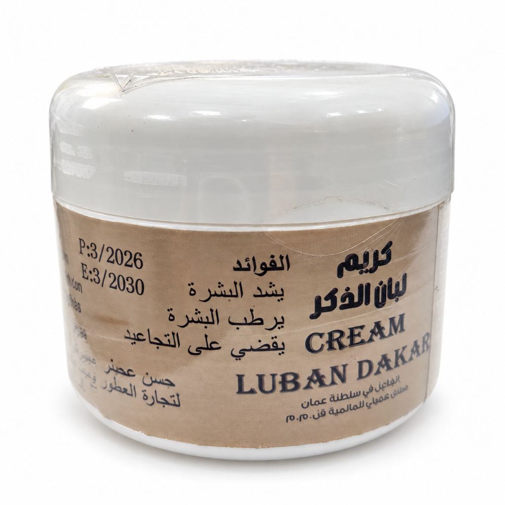 A white plastic jar of Luban Dakar Cream (Frankincense Cream) with a beige paper label featuring black Arabic and English text, set against a plain white background.