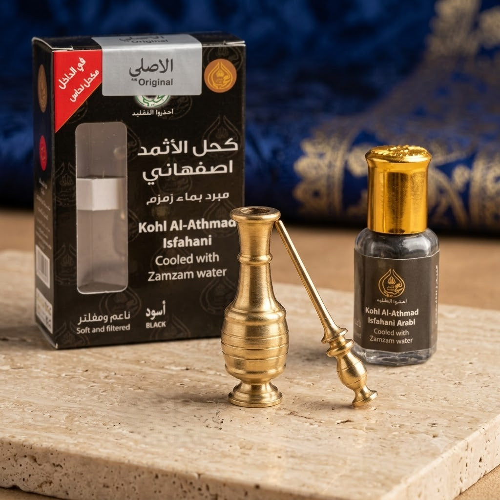 Kohl Al-Athmaad Isfahani with packaging and brass applicator on a wooden surface.