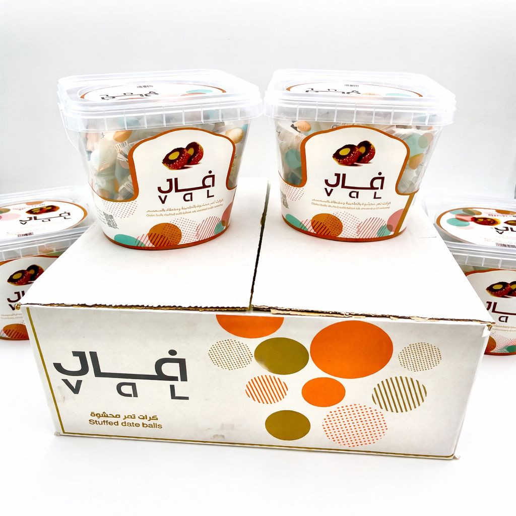 Two containers of stuffed date balls with a decorative box on a white background