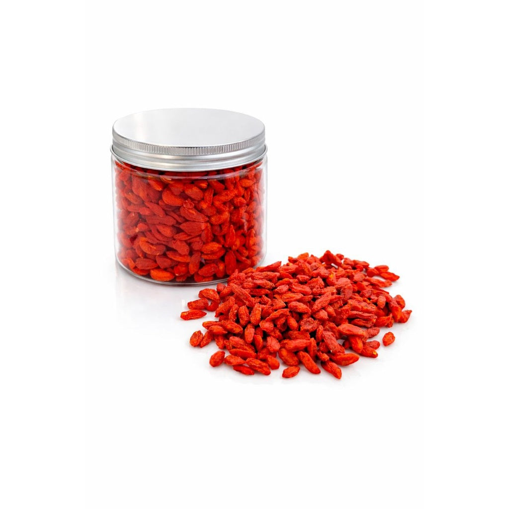 Jar of red goji berries (Barbarine) with some scattered on a white background