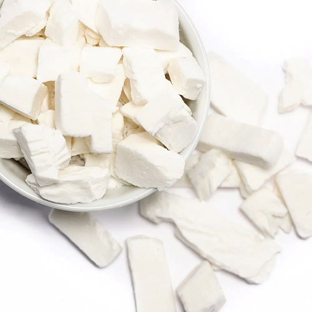 White cubes of a Freeze Dried Coconut in a bowl on a white background