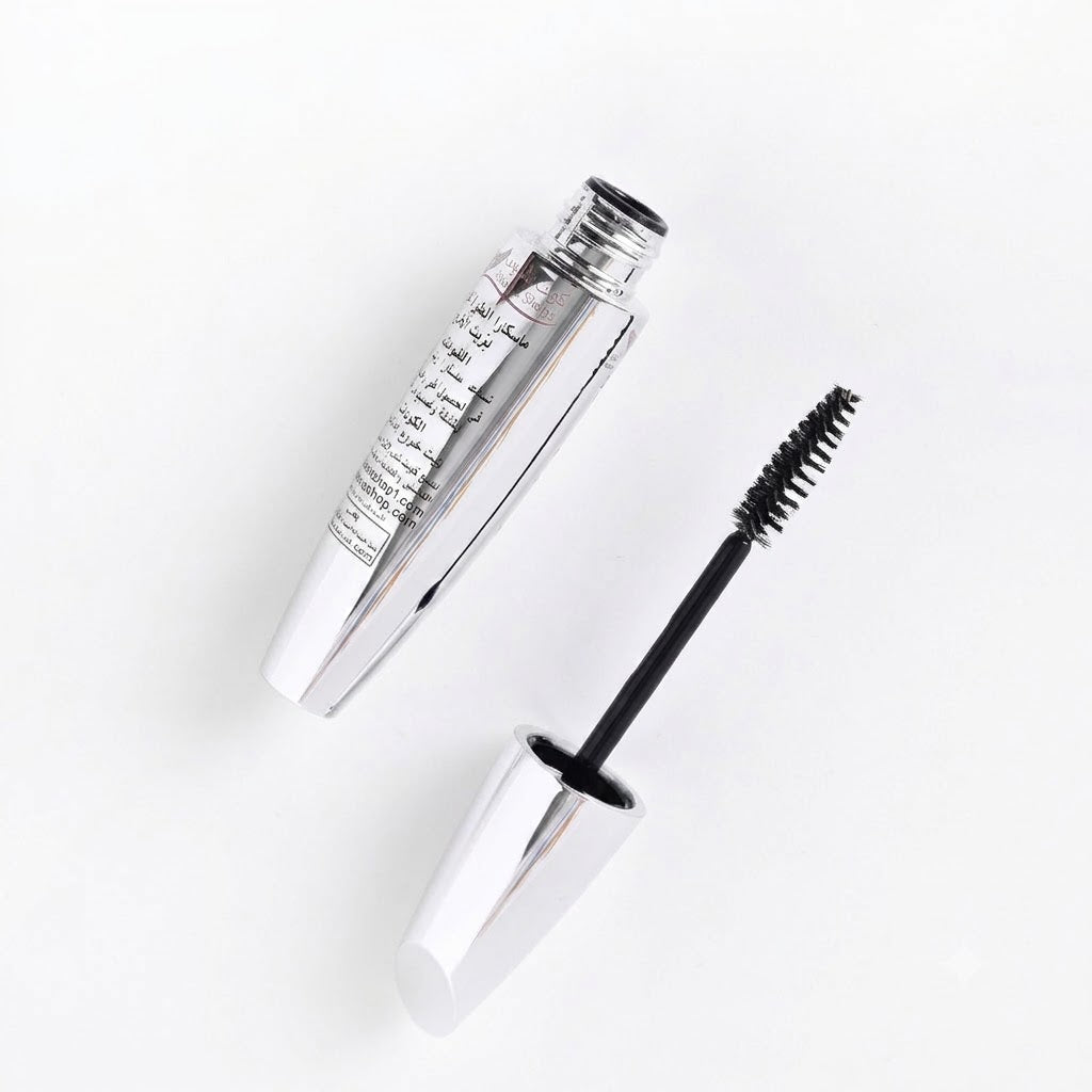 Mascara with silver casing and black brush on a white background