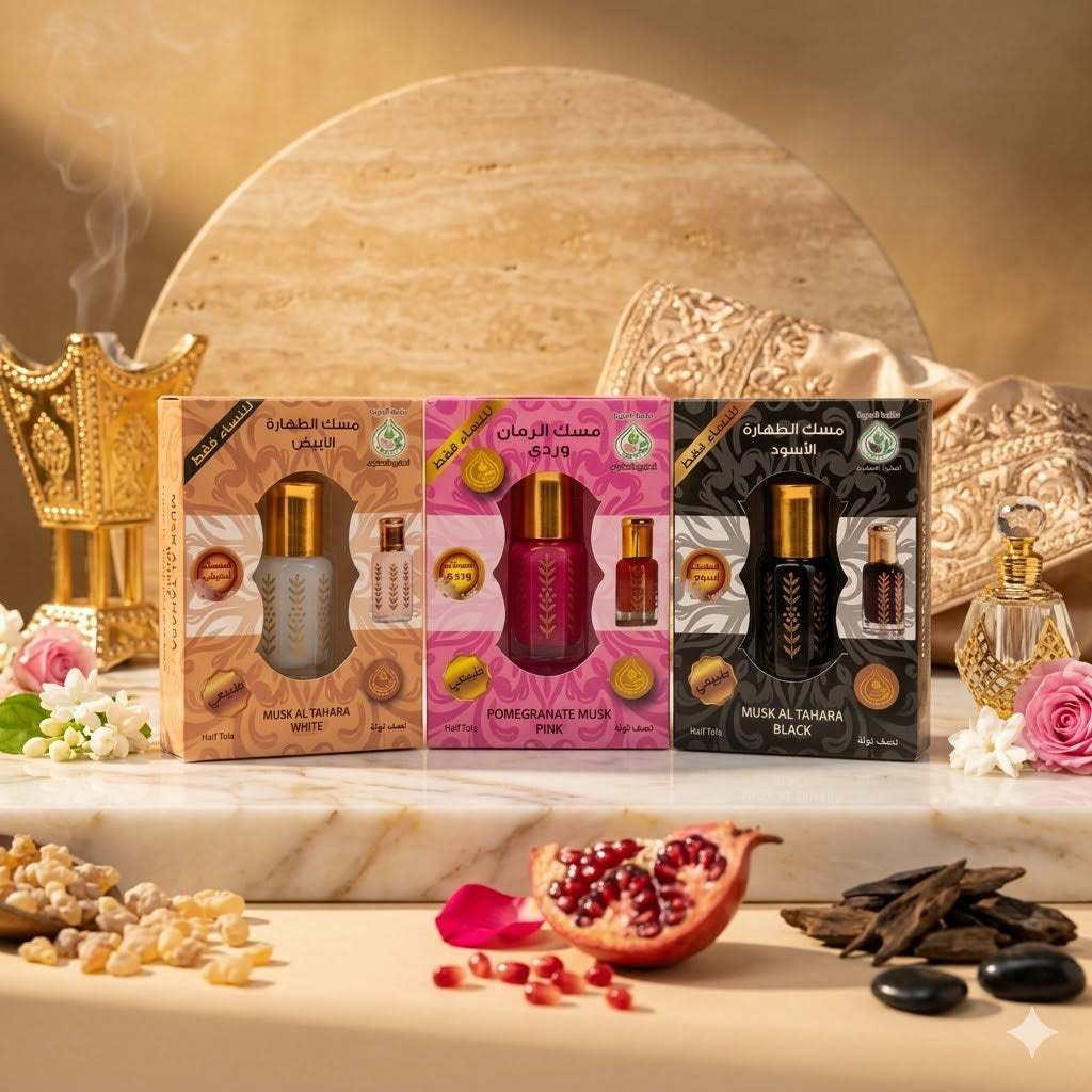 Three Musl Al Tahara boxes on a decorative table with pomegranate and flowers.